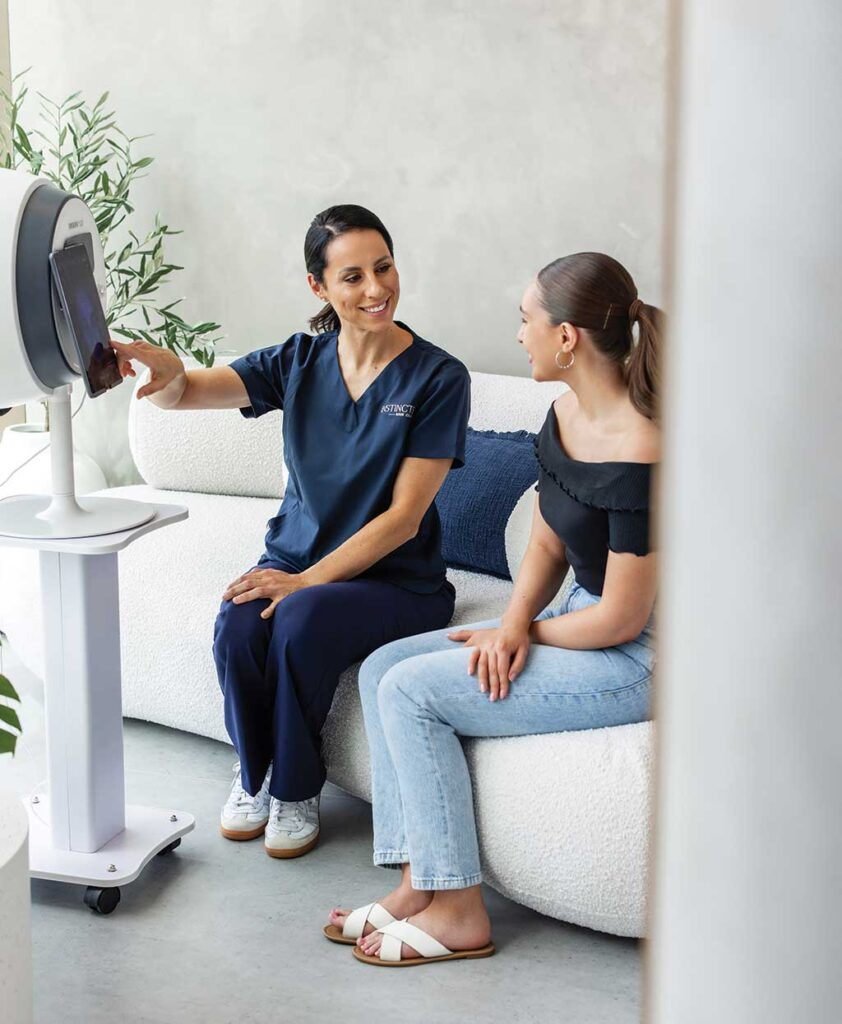An Instincts skin therapist reviewing skin analysis results with a client in the Bella Vista clinic
